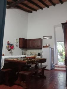 a kitchen with a table and a white refrigerator at Pure Alentejo Peroguarda Villa in Beja
