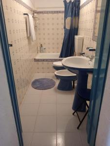 a bathroom with two toilets and a sink and a shower at Pure Alentejo Peroguarda Villa in Beja +28 photos