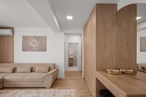 a living room with a couch and a table at Uno Deluxe Home Brasov in Braşov