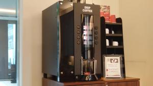 a black coffee machine sitting on a shelf at Richmond Hotel Tokyo Shiba in Tokyo