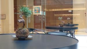 two tables and chairs with plants on top of them at Richmond Hotel Tokyo Shiba in Tokyo