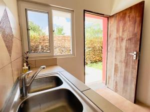 a kitchen with a sink and a window at Manasha Watamu in Watamu