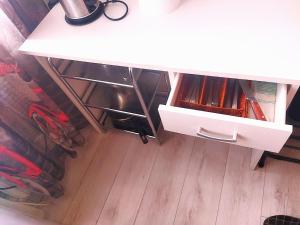 a white table with a drawer in a room at Itaja apartment 49 in Šiauliai
