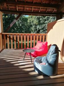 a porch with a bean bag chair and a table at Ferme ancienne des tilleuls in Vinay +1 photo