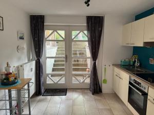 a kitchen with a door open to a patio at kleines Nordlicht in Eckernförde