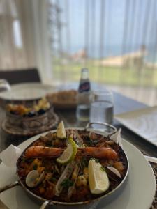 a plate of food with shrimp on a table at Villa La Falaise in Oualidia