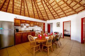 a kitchen with a table and chairs and a refrigerator at Short walk to pool and private beach in San Felipe