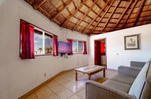 a living room with a couch and a table at Short walk to pool and private beach in Don Pancho