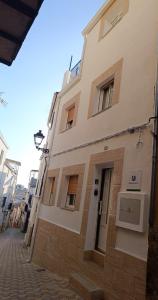 a tall white building on a city street at El Mirador in Chiclana de Segura