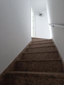 a stairway leading up to a white door at El Mirador in Chiclana de Segura +12 photos