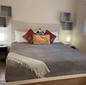 a bedroom with a large bed with many pillows at Sunset Hideaway in West Bay +19 photos