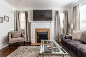 a living room with a couch and a fireplace at Tranquil Terrace - Whole Duplex in Corpus Christi