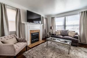 a living room with a couch and a fireplace at Tranquil Terrace - Whole Duplex in Corpus Christi