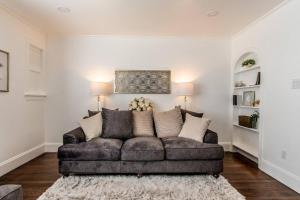 a living room with a brown couch in a room at Tranquil Terrace - Whole Duplex in Corpus Christi +65 photos