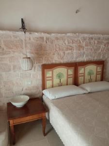 a bedroom with a bed and a bowl on a table at Trullo Amedee in Ostuni +37 photos