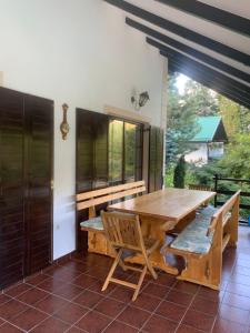 a dining room with a wooden table and chairs at Villa Smaragdis in Čerević