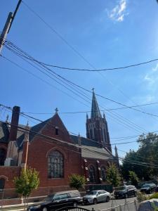 a large brick church with a tall steeple at Visit & Relax in Jamaica