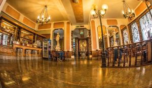 a lobby with chairs and tables in a building at Tourist Hotel in Potenza