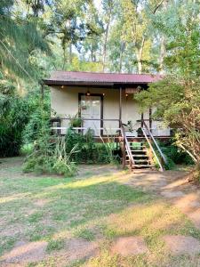 a small house with a staircase leading to it at Casa al rio - Malen in Tigre