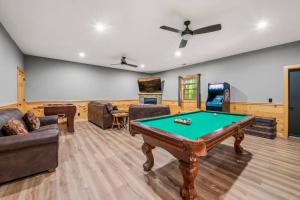 a living room with a pool table and a tv at Relax, Play & Enjoy Mountain Views and Hot Tub in Pittman Center