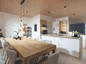 a kitchen and dining room with a wooden table and chairs at Holiday home Chalet 48 in Mayen