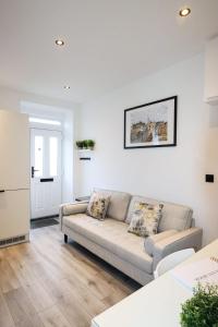 a living room with a couch and a table at City Centre Hub Stirling, On Street Parking. in Stirling