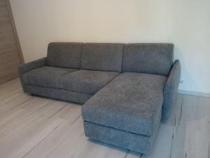 a gray couch with a ottoman in a living room at Makari Sweet Sunsets in Macari