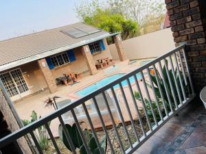 a house with a swimming pool next to a building at Melodie Guest House in Lone Star Texas