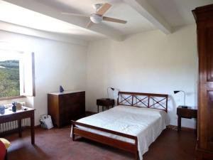 a bedroom with a bed and a ceiling fan at Podere Solatio - Tuscany Hills next to Florence in Impruneta