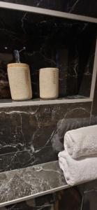 two towels on a shelf in a bathroom at Apt moderne en plein centre-ville in Saint-Claude