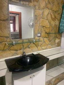 a bathroom with a black sink and a mirror at mono centro storico in Benevento