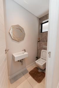a bathroom with a sink and a toilet at The paramount in Johannesburg +3 photos