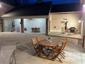 a patio with a table and chairs and a piano at Maison Marguerite in Chouilly
