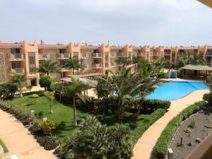 an aerial view of a resort with a pool and palm trees at Tropical Morabeza Apartment Santa Maria in Santa Maria