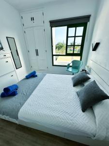 a bedroom with a large bed and a window at Bungalow Yaipe in Maspalomas +21 photos