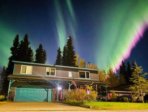 a house with a rainbow in the sky at Northern Knights in Fairbanks