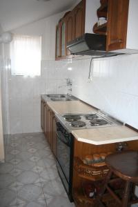 a kitchen with a stove and a counter top at Spacious 2Bedroom Flat Budva Becici in Boreti +19 photos