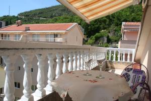 a table with wine glasses on a balcony at Spacious 2Bedroom Flat Budva Becici in Boreti