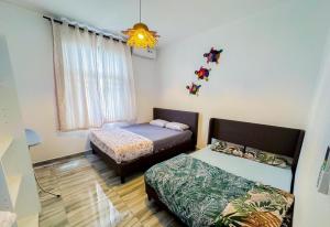 a room with two beds and a window at Villa Boulevard Paradise in Grand Baie +7 photos