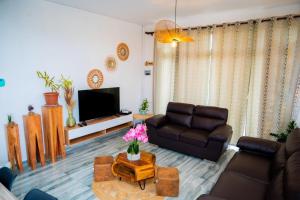 a living room with a couch and a table at Villa Boulevard Paradise in Grand Baie