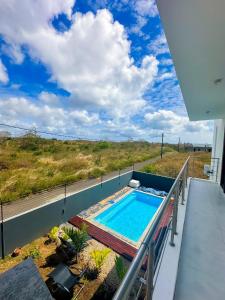 a swimming pool on the balcony of a house at Villa Boulevard Paradise in Grand Baie