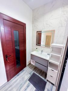 a bathroom with a sink and a red door at Villa Boulevard Paradise in Grand Baie