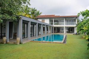 an exterior view of a house with a swimming pool at Villa Lagoonscape in Negombo
