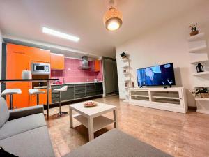 a living room with a couch and a tv at Melo Home 1 Near Airport, Elevator in Vecindario