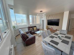 a living room with a table and chairs and a television at City Centre - Sleeps 4 & Free Parking in Birmingham