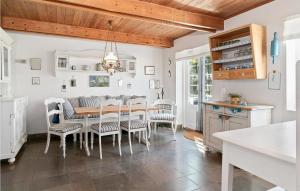 a dining room with a table and chairs at Drostgården in Humble