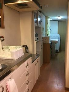 a kitchen with a sink and a counter top at ゲストハウス町家はま in Izumi-Sano +61 photos