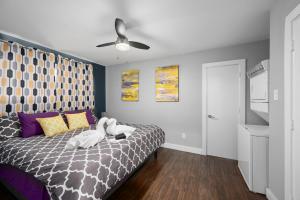 a bedroom with a bed with two swans on it at Stylish 1BR Apt - Steps from NRG and Texas Med Center in Houston