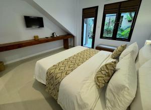 Postel nebo postele na pokoji v ubytování Ubud Gata Guest House