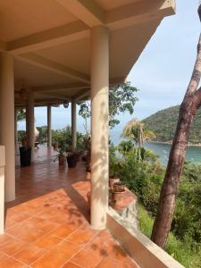 a porch of a house with a view of the ocean at Sky Temple Yelapa in Yelapa +65 photos